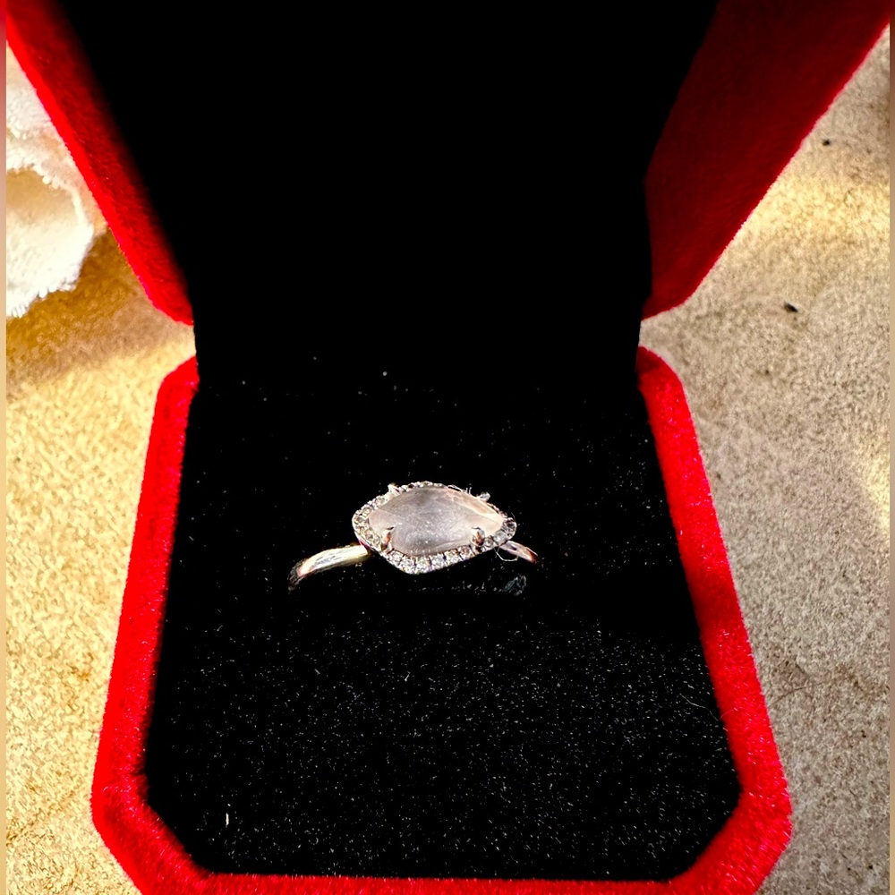 Raw rose quartz ring with diamond accents set in sterling silver